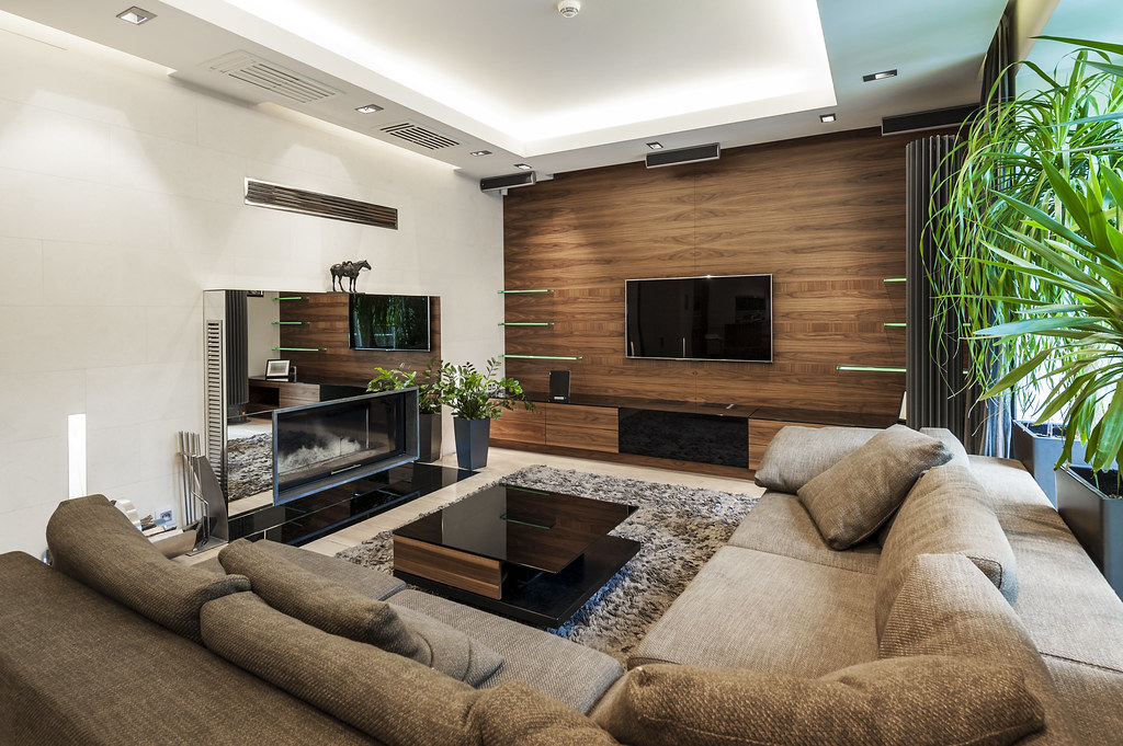 A living room with a fireplace and a carpet, restyled traditional English with dark green walls and the fireplace kept